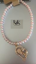 Pink and white pearl bracelet with gold-tone heart charm